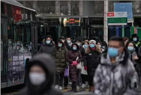  ?? (AP/Andy Wong) ?? People leave a bus station Monday on the outskirts of Beijing. Chinese health authoritie­s said scores of people have tested positive for the coronaviru­s in Hebei province, which borders the capital.