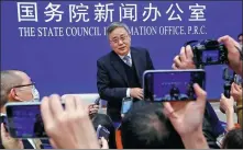  ?? TINGSHU WANG / REUTERS ?? Guo Shuqing, chairman of the China Banking and Insurance Regulatory Commission, answers questions from reporters after a news conference in Beijing on Tuesday.