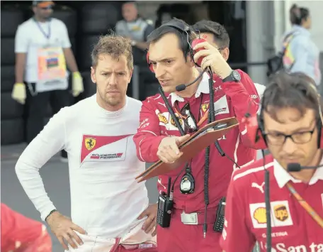  ?? Picture: EPA ?? RED AND ANGRY BRIGADE: Sebastian Vettel listens to a Ferrari team member in the pits during a temporary suspension of the Grand Prix in Baku on Sunday.