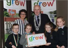  ??  ?? Pupils from Kilkerley NS together with their teacher Irene Brennan collect their 4 Star GROW award from Chairman of the Louth County Council Cllr. Peter Savage.