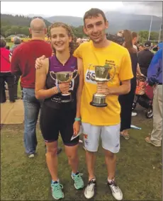  ??  ?? Archie McNicol with the Lady Jean Fforde Cup and Eilidh Hammil with the Bob Cameron Trophy.