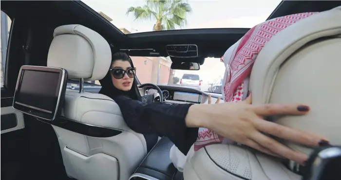  ?? AFP; Reuters ?? A Saudi woman practises driving in Riyadh under supervisio­n, above. As the ban ends, women will learn the practicali­ties of car maintenanc­e and hone their road skills, below