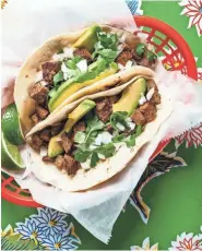  ?? STRICKLAND ROBERT ?? These carne asada tacos are a specialty of the popular Austin restaurant Tacodeli.