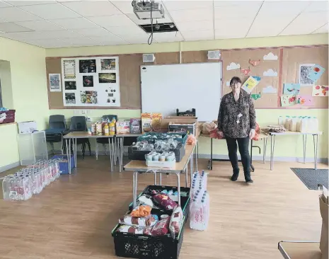  ??  ?? Acting deputy head of Hudson Road Primary School Maria McGrory with items donated to help families.