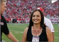  ?? (AP file photo) ?? Wendy Anderson, shown walking with her husband onto the field at Lincoln, Neb., before an Arkansas State game in 2017, died a year ago today after a lengthy battle with breast cancer. “I doubt I’ll ever not think about her,” Blake Anderson said. “I don’t want to ever not think about her because she was my best friend for 27 years.”