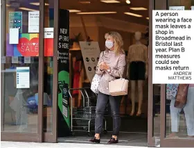 ?? ANDREW MATTHEWS ?? A person wearing a face mask leaves a shop in Broadmead in Bristol last year. Plan B measures could see masks return