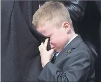  ?? CP PHOTO ?? Rob Ford’s son Dougie cries into his mother Renata’s coat as he watches his father’s casket being placed in the hearse following a funeral service at Toronto’s St. James Cathedral on Wednesday.