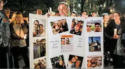  ??  ?? Jeff James, father of missing Duquesne University graduate student Dakota Leo James, holds a board covered in photos of his son during a vigil at Katz Plaza in the Cultural District on Monday.