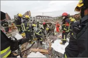  ?? COLOR CHINA PHOTO VIA AP ?? Rescuers search for victims Sunday in the debris of a collapsed building following a massive explosion in Ningbo, a port city south of Shanghai in east China’s Zhejiang province.