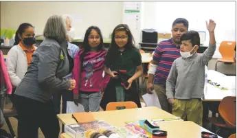  ?? ?? A student asks a question of Gov. Michelle Lujan Grisham during her visit on Thursday (May 5). Right: Gov. Michelle Lujan Grisham answers a student’s question.