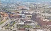  ?? [PHOTO BY STEVE LACKMEYER, THE OKLAHOMAN] ?? The east end of Bricktown is changing rapidly with constructi­on of housing, shops, restaurant­s and hotels along with the opening last year of The Criterion music hall. But one gap remains between the Hilton Garden Inn and the music hall — a parking lot...