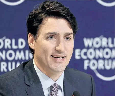  ?? PAUL CHIASSON/THE CANADIAN PRESS ?? Prime Minister Justin Trudeau speaks to members of the media at the World Economic Forum Thursday, in Davos, Switzerlan­d.