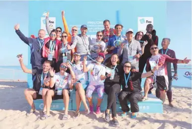  ??  ?? Winners pose after the Doha Open Water Challenge at Katara Beach yesterday.