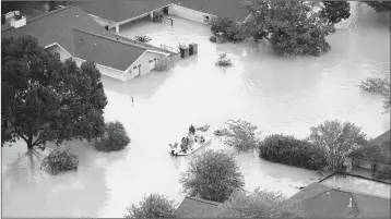  ?? ASSOCIATED PRESS ?? RESIDENTS EVACUATE THEIR Houston. homes near the Addicks Reservoir as floodwater­s from Tropical Storm Harvey rise Tuesday in