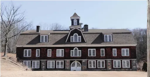  ??  ?? BELOW: This distinctiv­e structure on Joshuatown Road in Lyme was built in 1907 as a barn for cows and horses. It was later turned into a residence and art studio known as Bull Run Hill.