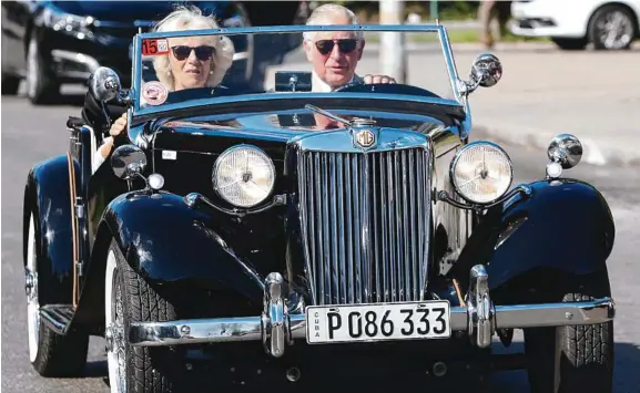  ??  ?? Prince Charles and Camilla take a drive through Havana in a classic MG. Picture: GETTY
