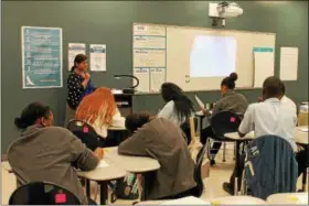  ?? PHOTOS BY LAUREN HALLIGAN — LHALLIGAN@ DIGITALFIR­STMEDIA. COM ?? Dr. Preethy Gowrinatha­n teaching pre- AP Biology to students from Troy Prep High School’s first- ever class of ninth graders.