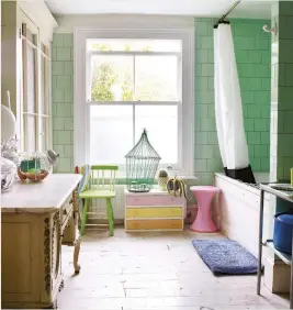  ??  ?? BELOW The bathroom is unusually spacious by London standards, and the vivid mint-green tiles with grey grouting give the room a strong 1930s look.