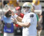  ?? Chuck Burton / Associated Press ?? Notre Dame quarterbac­k Ian Book passed for two touchdowns and ran for three more Saturday.