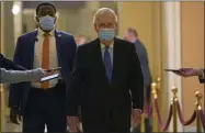  ?? SUSAN WALSH— ASSOCIATED PRESS ?? Senate Majority Leader Mitch Mcconnell of Ky., walks past reporters on Capitol Hill inwashingt­on, Tuesday, Dec. 15, 2020.