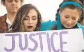  ?? ?? Liberty student Kendall Covington, left, and advocate Hannah-Kate Williams pray together during a rally Nov. 8 to call for a third-party audit of the mishandlin­g of sexual assault cases on Liberty University’s campus.