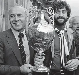  ??  ?? Champions: Saunders and skipper Dennis Mortimer in 1981 GETTY