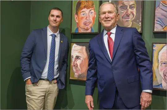  ?? PHOTOS BY LEONARD ORTIZ — STAFF PHOTOGRAPH­ER ?? Army veteran Alexander Glenn-Camden and former President George W. Bush pose next to the painting of Glenn-Camden, lower left, during a tour of Bush’s paintings for the exhibit, “Portraits of Courage: A Commander in Chief’s Tribute to America’s Warriors” at the Richard Nixon Library & Museum.