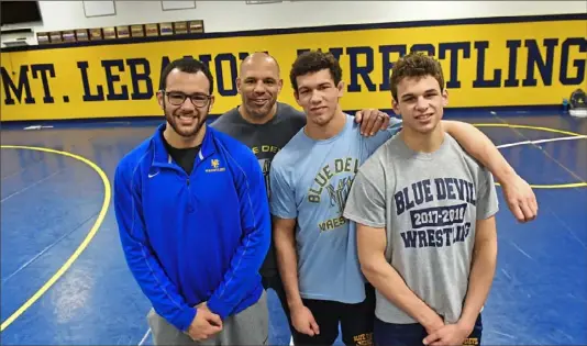  ?? Matt Freed/Post-Gazette ?? Bryan Stout, second from left, a standout wrestler in his day, poses with his three outstandin­g wrestling sons: Kellan, left, Luke and Mac.