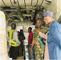  ?? ?? INEC Chairman, Prof. Mahmood Yakubu ( right), watch keenly as Bimodal Voter Accreditat­ion System ( BVAS) machines in cartons are arranged in the Nigeria Air Force C- 130 plane for airlifting to states under the supervisio­n of Air Force Officers at the Murtala Mohammed Airport, Ikeja, Lagos… yesterday.