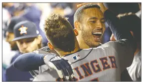  ?? AP/PATRICK SEMANSKY ?? Houston Astros’ Carlos Correa celebrates Sunday in the dugout with George Springer after his tworun home run against the Washington Nationals during the fourth inning of Game 5 of the World Series in Washington.