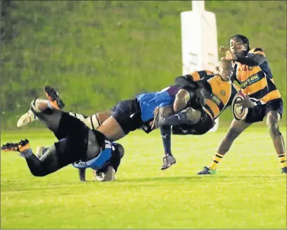  ?? Picture: SINO MAJANGAZA ?? UNFAIR ODDS: Odwa Rasmeni of Police gets crash-tackled during the game against Cambridge at the Old Selbornian club