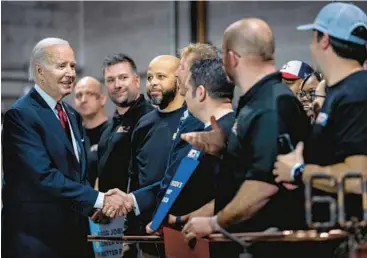  ?? ANDREW HARNIK/AP ?? President Joe Biden greets audience members Thursday at a steamfitte­rs union hall in Springfiel­d, Virginia.