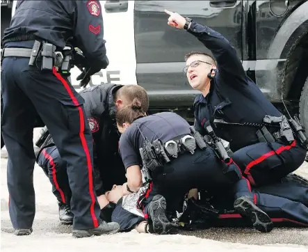  ?? DARREN MAKOWICHUK ?? Calgary Police tend to one of their own who was shot in Abbeydale on Tuesday. Some people objected to release of video footage.