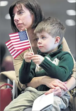  ?? PHOTOS BY YALONDA M. JAMES/THE COMMERCIAL APPEAL ?? Starkville, Miss., resident Rosa Nigro Taquino (with her son Michael Taquino, 4) has lived in the United States for 15 years. She became a naturalize­d citizen Wednesday during the ceremony at the Benjamin L. Hooks Central Library.