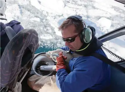  ?? Tony Cenicola / New York Times ?? Gordon Hamilton takes measuremen­ts on the Helheim glacier in Greenland in 2010. Hamilton died last week when his snowmobile went into a deep crevasse.