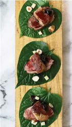  ??  ?? Betel leaves with five-spice duck, foie gras and Shaoxing rice wine and stewed cherry sauce.