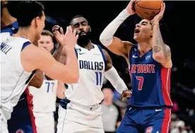  ?? Carlos Osorio/associated Press ?? Detroit guard Killian Hayes attempts a shot as Dallas center Dwight Powell, left, and forward Tim Hardaway Jr. defend during Thursday’s game.