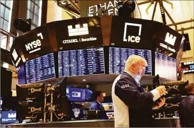  ?? Getty Images ?? Traders work on the floor of the New York Stock Exchange during morning trading on Thursday. Stocks shook off a midday slump and ended higher Thursday, keeping the market on track for its first weekly gain after three weeks of punishing losses.