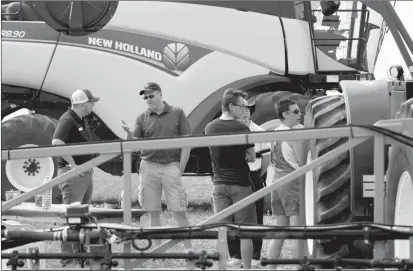  ?? Herald photo by Greg Bobinec ?? Brendan Nicol, Digital Farming Specialist through Xarvio, talks with people about their new app that helps you identify different types of weeds at the Farming Smarter Open Farm Days on Saturday morning.