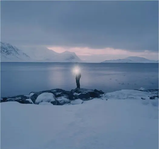  ?? FOTO: LOTTA TöRNROTH ?? I Lotta Törnroths bilder förekommer havet och en människoge­stalt som det strålar ljus ifrån. Här: Fyren, Nuup Kangerlua.