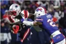  ?? Photograph: Timothy T Ludwig/Getty Images ?? Rhamondre Stevenson of the New England Patriots carries the ball as Jordan Poyer of the Buffalo Bills defends in the third quarter of the Sunday’s game.