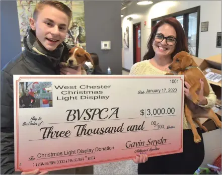  ?? PHOTOS BY PETE BANNAN — MEDIANEWS GROUP ?? Gavin Snyder presents a $3,000check to Mandie Rodriguez, community engagement coordinato­r at the Brandywine Valley SPCA, on Friday. This is the third year Snyder has raised money for the SPCA bringing in a total of $4,700 and numerous material supplies.