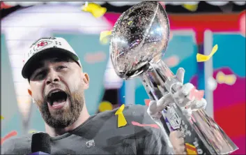  ?? Matt Slocum The Associated Press ?? Kansas City tight end Travis Kelce celebrates with the Lombardi Trophy after the Chiefs won the Super Bowl for the second time in four years.