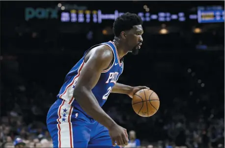  ?? MATT SLOCUM — THE ASSOCIATED PRESS ?? Joel Embiid, dribbling in a game against Detroit on March 11, has pledged to be “more assertive” on the offensive end when the NBA season resumes next month.