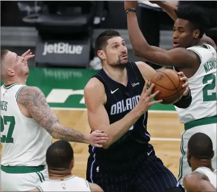  ?? MICHAEL DWYER - THE ASSOCIATED PRESS ?? Orlando Magic’s Nikola Vucevic (9) drives past Boston Celtics’ Daniel Theis (27) and Semi Ojeleye (37) during the second half on an NBA basketball game, Sunday, March 21, 2021, in Boston.