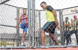  ?? CONTRIBUTE­D ?? Kevin Kellyman (left) fires a fierce shot on goal that is blocked by Roshede Bald as they square off in the inaugural National Final of the LASCO iDrade Cage Football Challenge on Sunday at Mandela Park in Half-Way Tree. Bald walked away with the...