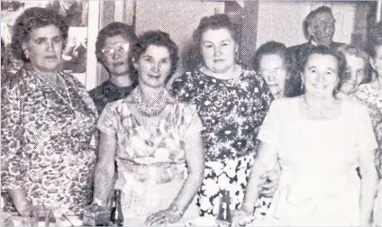  ?? SOCIETY OF CARPATHO-RUSSIAN CANADIANS ?? Annie Hrynchak (at far left in front row), Nellie Handiak (centre, with her hands on the table) and Anna Baran (right) are shown in an archival photo of the women who often cooked meals for the Society of Carpatho-Russian Canadians, which regularly held dances at its hall on Queen St. W.