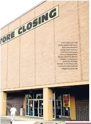  ?? AP ?? In this July 8, 2017 file photo, people walk into a Sears store slated for closing that is next to a mall that is being torn down in Overland Park, Kansas. Sears has filed for Chapter 11 bankruptcy protection Monday, October 15, buckling under its massive debt load and staggering losses.