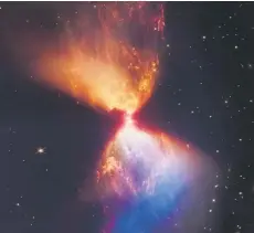  ?? — AFP photo ?? Undated composite handout image from Nasa’s James Webb Space Telescope Near-Infrared Camera (NIRCam) released by Nasa and STScl, shows the Protostar within the dark cloud L1527 with ejections from the star above and below appear orange and blue in infrared view.