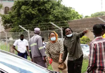  ??  ?? An unidentifi­ed motorist threatens to stone a parking marshal for clamping his vehicle along Herbert Chitepo Avenue in Harare yesterday. — Picture: Innocent Makawa